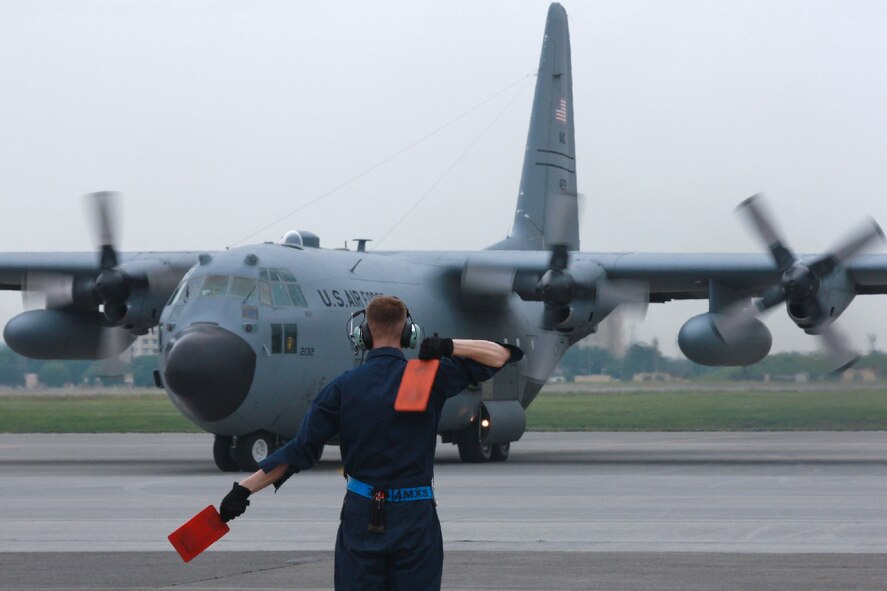 YOKOTA AIR BASE, Japan -- Staff Sgt. Jonathan Callahan, 374th Aircraft Maintenance Squadron crew chief, marshalls a C-130 Hercules during the Samurai Surge exercise at Yokota Air Base, Japan, on June 5, 2012. (Courtesy photo by Chiyo Sakai)