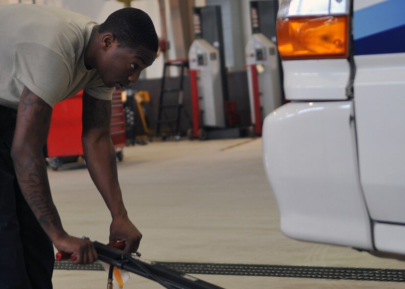 Airman 1st Class Maxmarcian NIamkey, 51st Logistics Readiness Squadron vehicle equipment maintenance journeyman, positions a hydraulic jack under a vehicle while performing an oil change at Osan Air Base, Republic of Korea, June 6, 2012. The 51st LRS maintains approximately 1,400 vehicles on base.  (U.S. Air Force photo/Staff Sgt. Craig Cisek)
