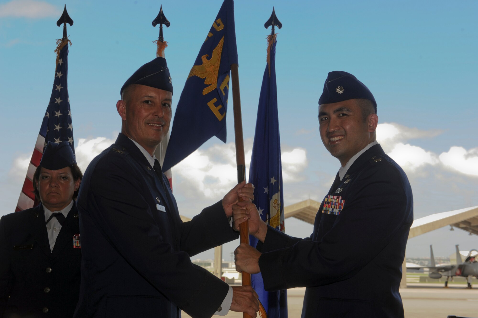 U. S. Air Force Lt. Col. John Tran, 18th Equipment Maintenance Squadron commander, accepts the guidon from Col. Brian Beers, 18th Maintenance Group commander, during a change of command ceremony on Kadena Air Base, Japan, June 6, 2012. Tran comes from Yokota Air Base, Japan, where he worked as the government relations branch chief directorate. The 18th EMS supports heavy maintenance for Kadena-assigned aircraft, F-15s, KC-135s and HH-60s; and limited maintenance to associate H/MC-130, RC-135; and transient C-5, C-17 and C-130 aircraft.  (U.S. Air Force photo/Airman 1st Class Justin Veazie)