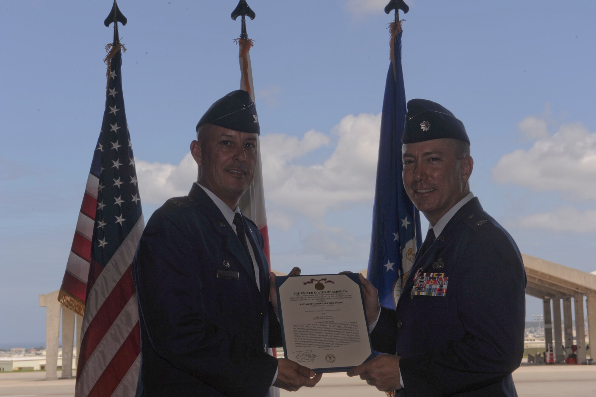 U.S. Air Force Lt. Col. Stephen Harvey, former 18th Equipment Maintenance Squadron commander receives the Meritorious Service Medal from Col. Brian Beers, 18th Maintenance Group commander, during a change of command ceremony on Kadena Air Base, Japan, June 6, 2012. The MSM is a military decoration presented to members of the United States Armed Forces who distinguished themselves by outstanding meritorious achievement or service to the United States. (U.S. Air Force photo/Airman 1st Class Justin Veazie)