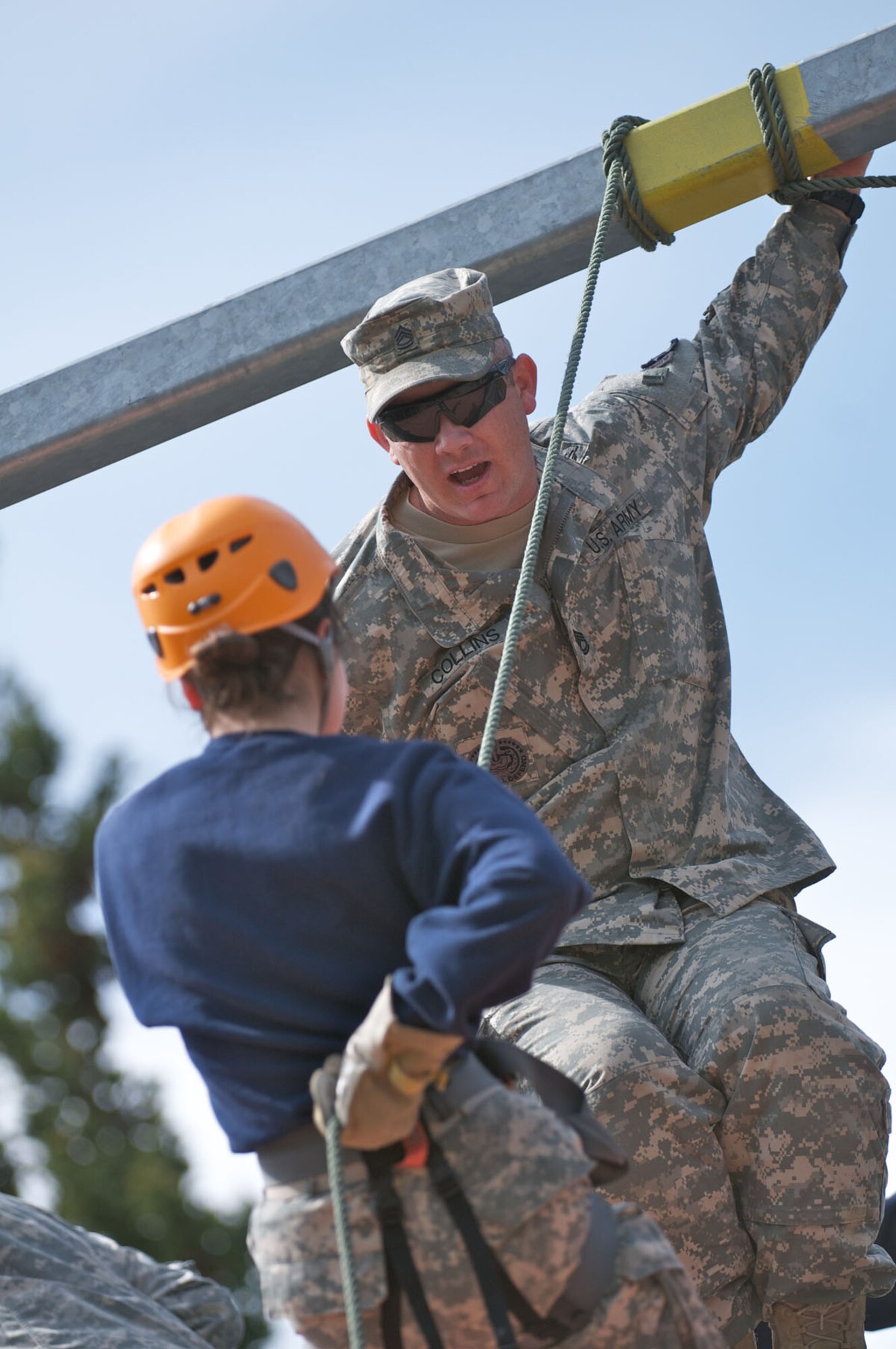 JOINT BASE ELMENDORF-RICHARDSON, Alaska -- Sgt. 1st Class Joshua Collins, 1st Battalion (Airborne), 501st Infantry Regiment, a native of Garfield, Ark., talks to Bartlett High School Junior ROTC Cadet Jessica Romero, 16, during rappel training at Camp Carroll June 1. Cadets stayed at JBER for a week during JROTC Cadet Leadership Challenge. (U.S. Air Force photo/David Bedard)