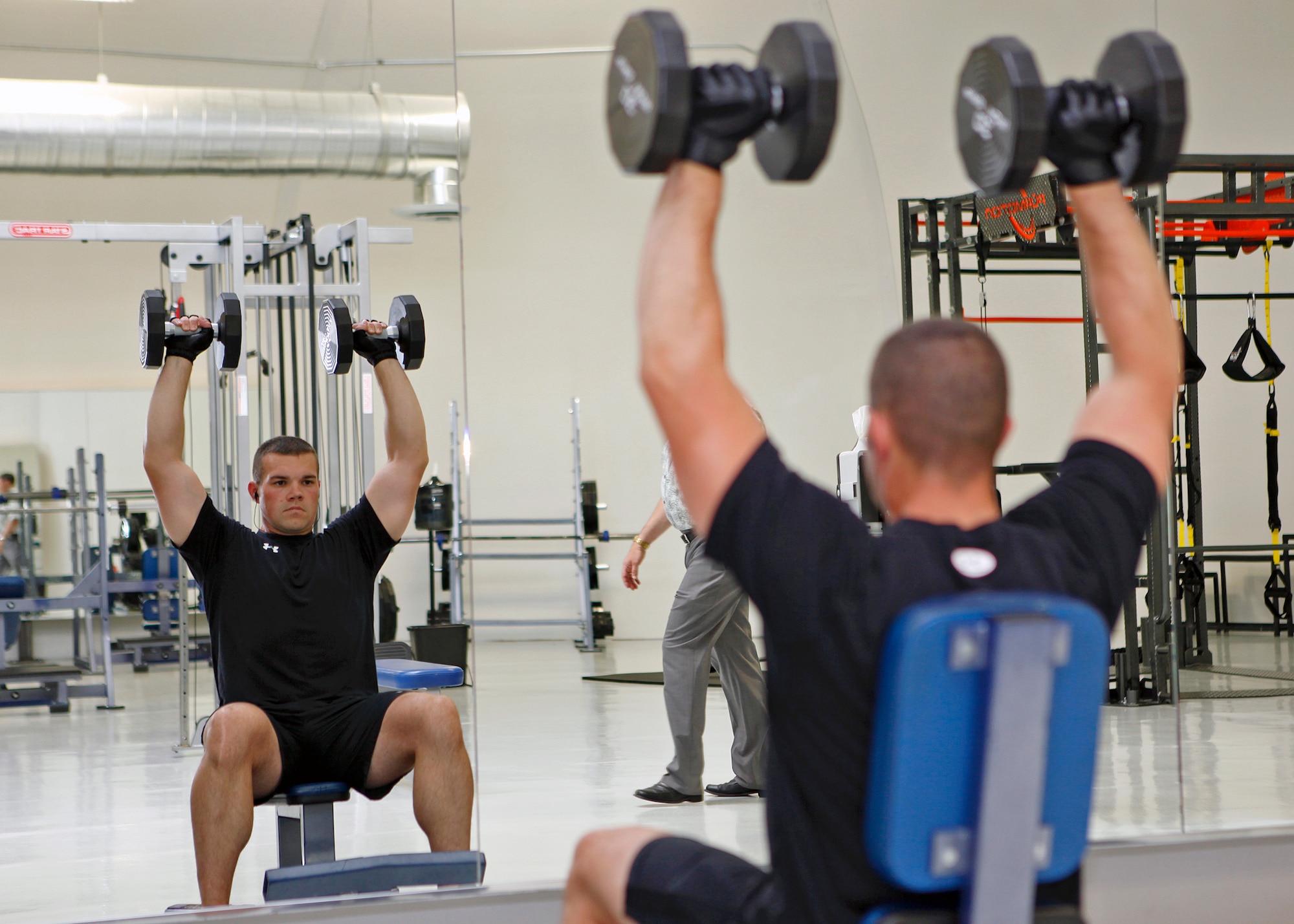 Staff Sgt. Cody Briggs, 412th Maintenance Squadron heavy maintenance technician, goes through his early morning workout routine in the base's new High Intensity and Free Weight workout facility, which had its grand opening June 4. Briggs was just one of the many individuals who had the opportunity to work out in this new temporary fitness center facility at Edwards Air Force Base, Calif. (U.S. Air Force photo by Jet Fabara)
