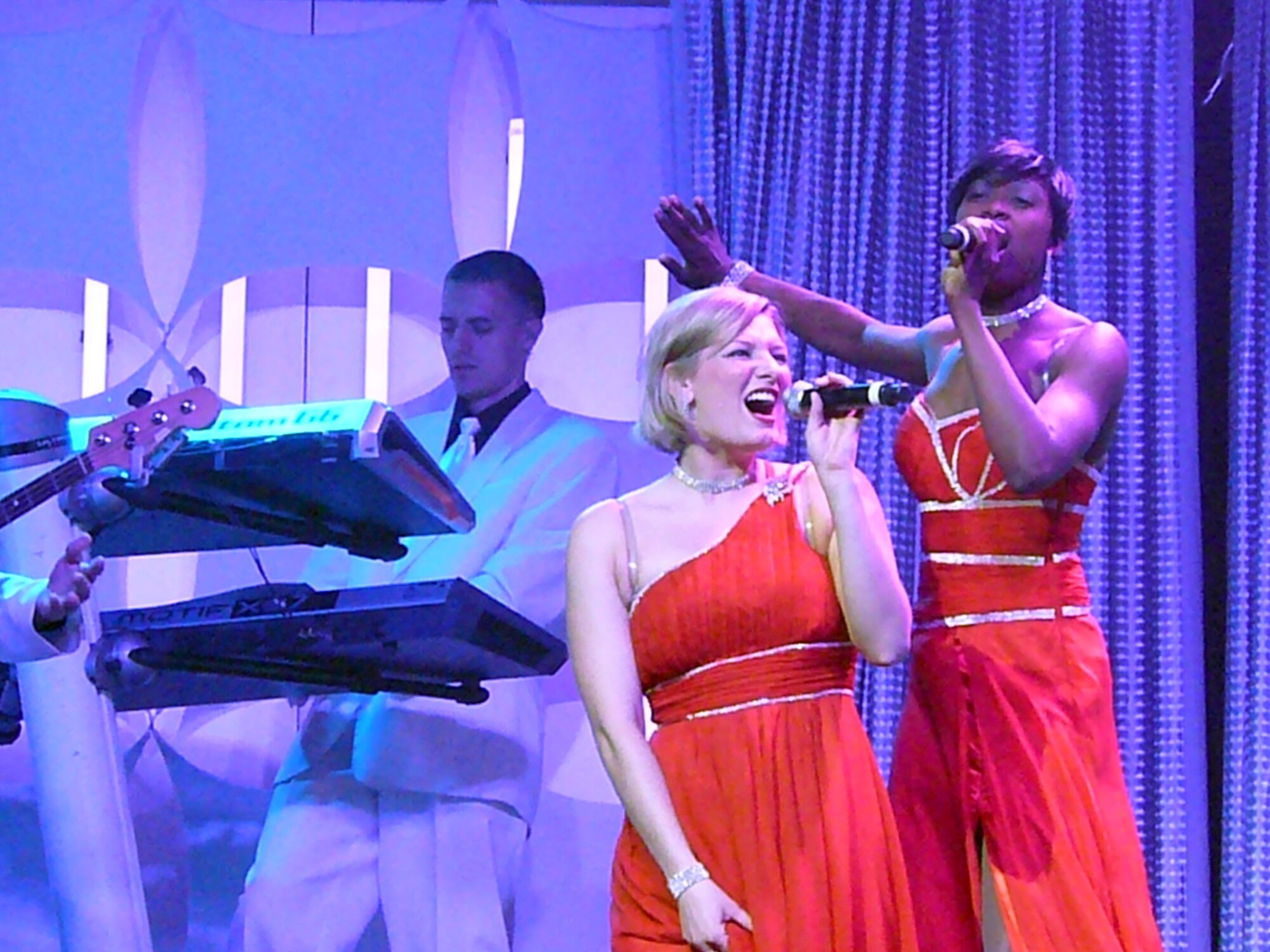 Senior Airman Joleen Dedmon (front), 944th Medical Group dental assistant, performs with the Tops In Blue entertainment group during their Phoenix show June 5. Tops in Blue’s 29 members took center stage at the Grand Canyon University Arena performing a free, 90–minute show, inviting people to “Listen” to the music of life through the sounds we hear every day. (U.S. Air Force photo by Capt. Elizabeth Magnusson)
