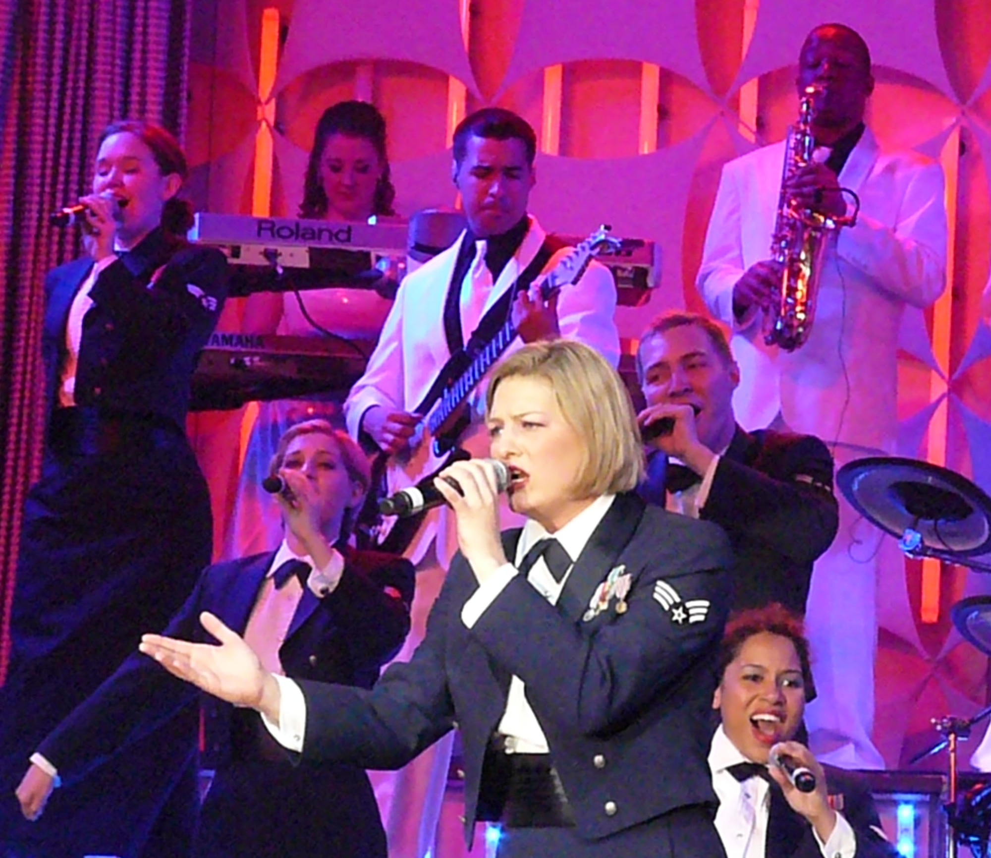 Senior Airman Joleen Dedmon, 944th Medical Group dental assistant, performs with the Tops In Blue entertainment group during their Phoenix show June 5. Tops in Blue’s 29 members took center stage at the Grand Canyon University Arena performing a free, 90–minute show, inviting people to “Listen” to the music of life through the sounds we hear every day. (U.S. Air Force photo by Capt. Elizabeth Magnusson)