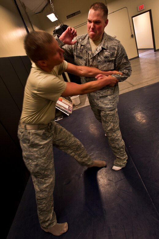 Staff Sgt. Michael Mattern, 628th Security Forces Squadron patrolman, moves to strike Airman 1st Class Michael Compson, 628th SFS patrolman, during Personal Apprehension Restraint Techniques and Mechanical Advantage Control Hold training at the combat arms building on Joint Base Charleston - Air Base, S.C., June 5, 2012. The training is an annual requirement for the Airmen in case of a physical situation while on duty. (U.S. Air Force photo by Airman 1st Class George Goslin)