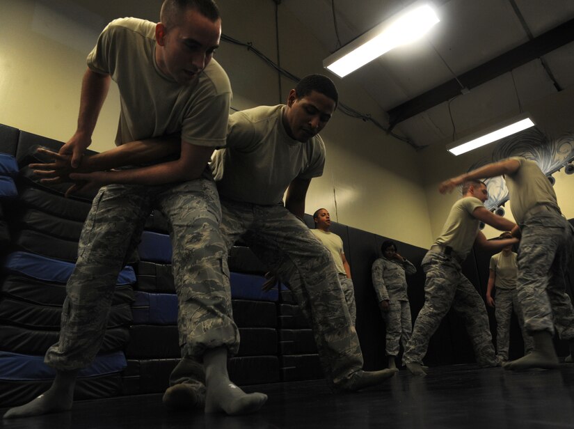 Airman 1st Class Justin Olson, 628th Security Forces Squadron and Airman 1st Class Kyren Gantt, 628th SFS, practice restraint techniques June 5, 2012 at Joint Base Charleston, S.C. Security Forces practice weapon retention, physical apprehension and restraint techniques as an annual training requirement. (U.S. Air Force photo/Airman 1st Class Ashlee Galloway)