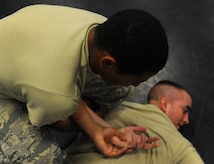 Airman 1st Class Justin Olson, 628th Security Forces Squadron and Airman Kyren Gantt, 628th SFS, practice restraint techniques June 5, 2012 at Joint Base Charleston, S.C. Security Forces practice weapon retention, physical apprehension and restraint techniques as an annual training requirement. (U.S. Air Force photo/Airman 1st Class Ashlee Galloway)