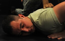 Airman 1st Class David Rao, 628th Security Forces Squadron, takes part in restraint techniques training June 5, 2012 at Joint Base Charleston, S.C. Security Forces practice weapon retention, physical apprehension and restraint techniques as an annual training requirement. (U.S. Air Force photo/Airman 1st Class Ashlee Galloway)