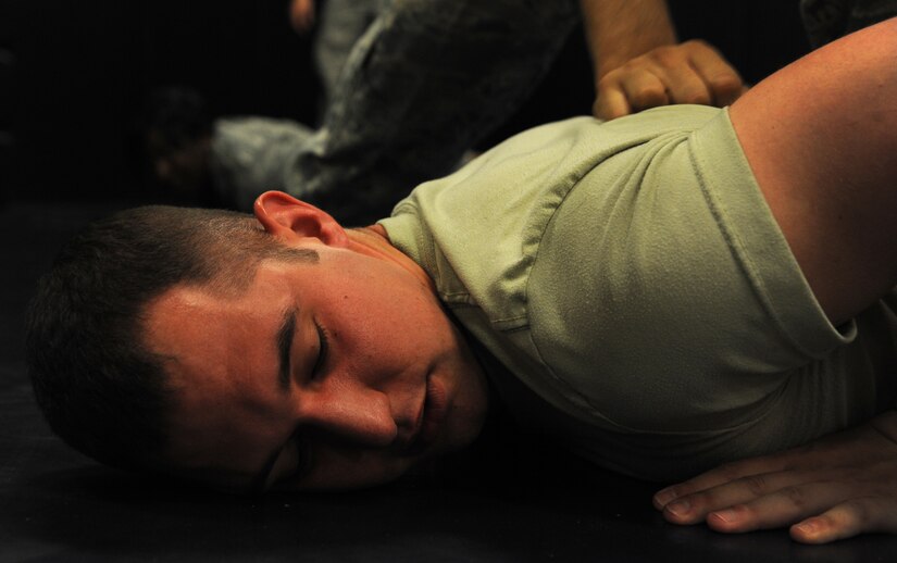 Airman 1st Class David Rao, 628th Security Forces Squadron, takes part in restraint techniques training June 5, 2012 at Joint Base Charleston, S.C. Security Forces practice weapon retention, physical apprehension and restraint techniques as an annual training requirement. (U.S. Air Force photo/Airman 1st Class Ashlee Galloway)