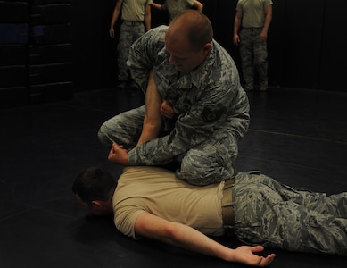 Tech. Sgt. John Foster, 628th Security Forces Squadron, demonstrates restraint techniques on Senior Airman Stephen Strickland, 628th SFS, June 5, 2012 at Joint Base Charleston, S.C. Security Forces practice weapon retention, physical apprehension and restraint techniques as an annual training requirement. (U.S. Air Force photo/Airman 1st Class Ashlee Galloway)