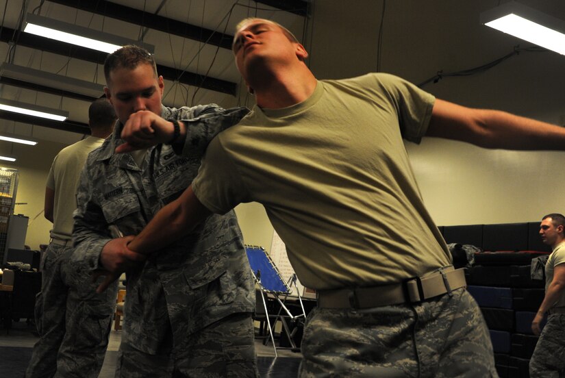 Staff Sgt. Michael Mattern, 628th Security Forces Squadron and Airman 1st Class Michael Compson, 628th SFS, practice restraint techniques June 5, 2012 at Joint Base Charleston, S.C. Security Forces practice weapon retention, physical apprehension and restraint techniques as an annual training requirement. (U.S. Air Force photo/Airman 1st Class Ashlee Galloway)