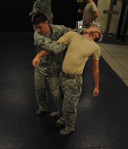 Senior Airman Curtis March, 628th Security Forces Squadron and Senior Airman Stephen Strickland, 628th SFS, practice restraint techniques June 5, 2012 at Joint Base Charleston, S.C. Security Forces practice weapon retention, physical apprehension and restraint techniques as an annual training requirement. (U.S. Air Force photo/Airman 1st Class Ashlee Galloway)