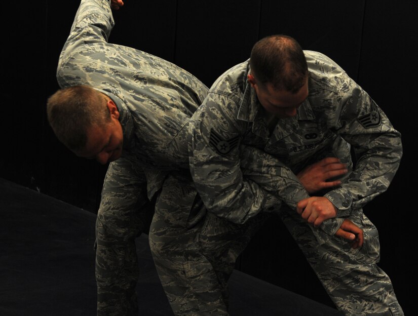 Airman 1st Class Michael Compson, 628th Security Forces Squadron and Staff Sgt. Michael Mattern, 628th SFS, practice restraint techniques June 5, 2012 at Joint Base Charleston, S.C.  Security Forces practice weapon retention, physical apprehension and restraint techniques as an annual training requirement. (U.S. Air Force photo/Airman 1st Class Ashlee Galloway) 