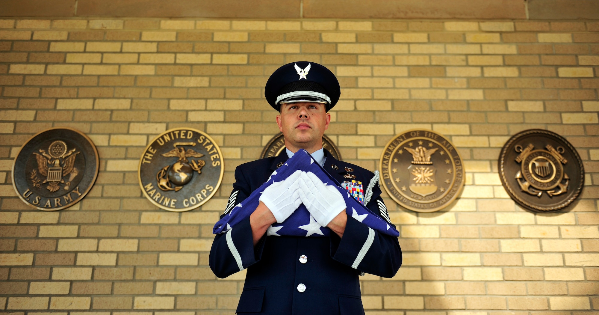FORT LOGAN, Colo. -- Tech. Sgt. Wolfram Stumpf, 460th Force Support Squadron Mile High Honor Guard flight chief, holds a folded American flag before presenting it to the next-of-kin of a deceased military veteran June 5, 2012 at Fort Logan National Cemetery. Honor guard members conduct various ceremonial activities. (U.S. Air Force Photo/ Senior Airman Paul Labbe) 