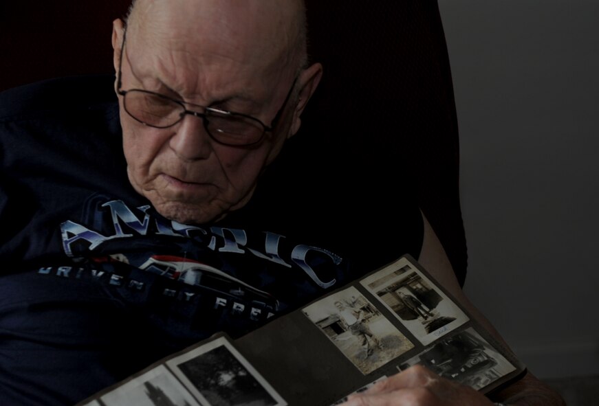 John Coons flips through an old photo album at his Hampton, Va. home, June 6, 2012. Coons was a private first class in the U.S. Army during World War II. (U.S. Air Force photo by Senior Airman Jarad A. Denton)