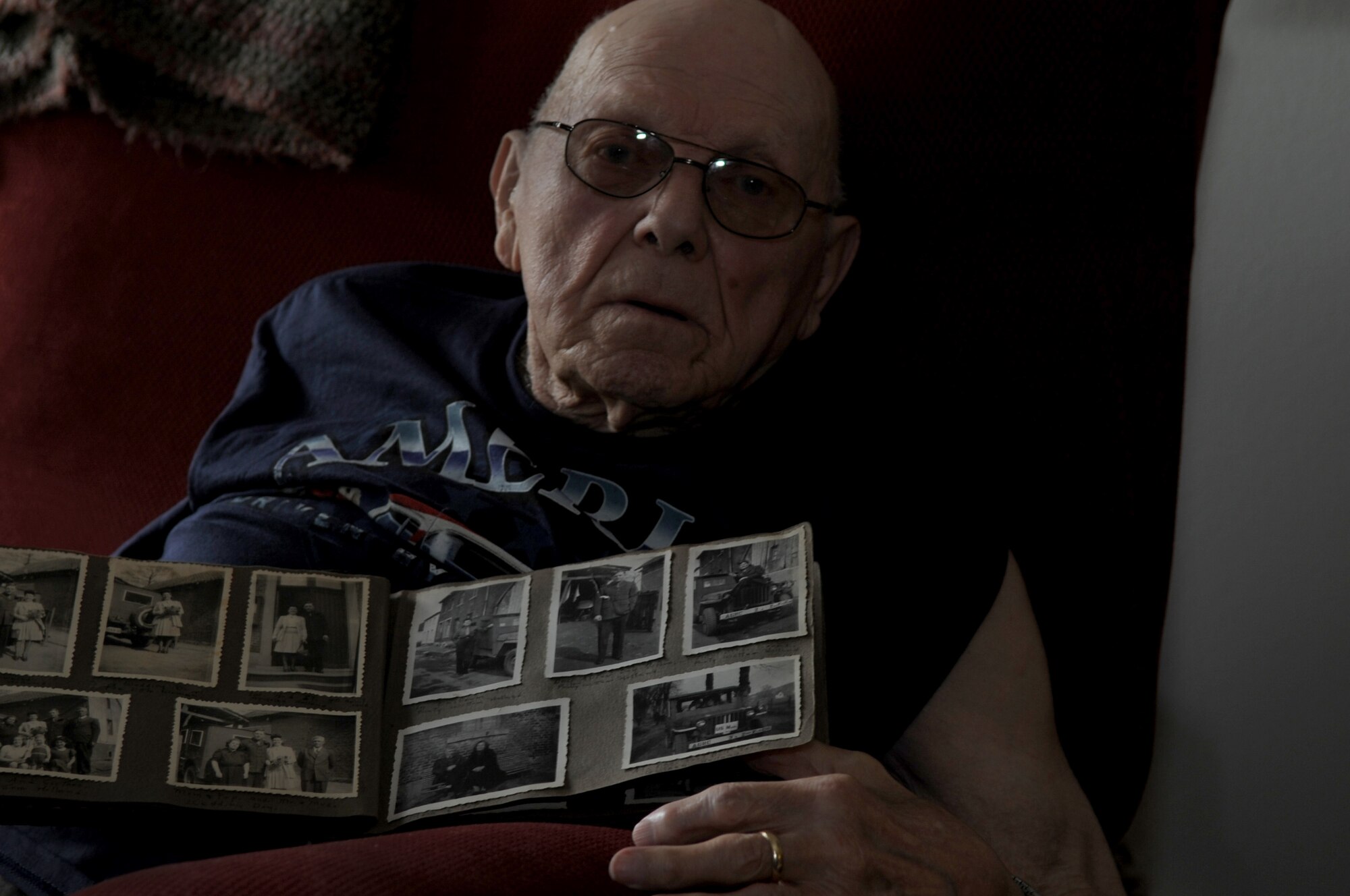 John Coons shows off photos, at his home in Hampton, Va., June 6, 2012, from his experiences as a Soldier during World War II. Coons, who is 90-years-old, was drafted into the U.S. Army when he was only 21. (U.S. Air Force photo by Senior Airman Jarad A. Denton/Released)