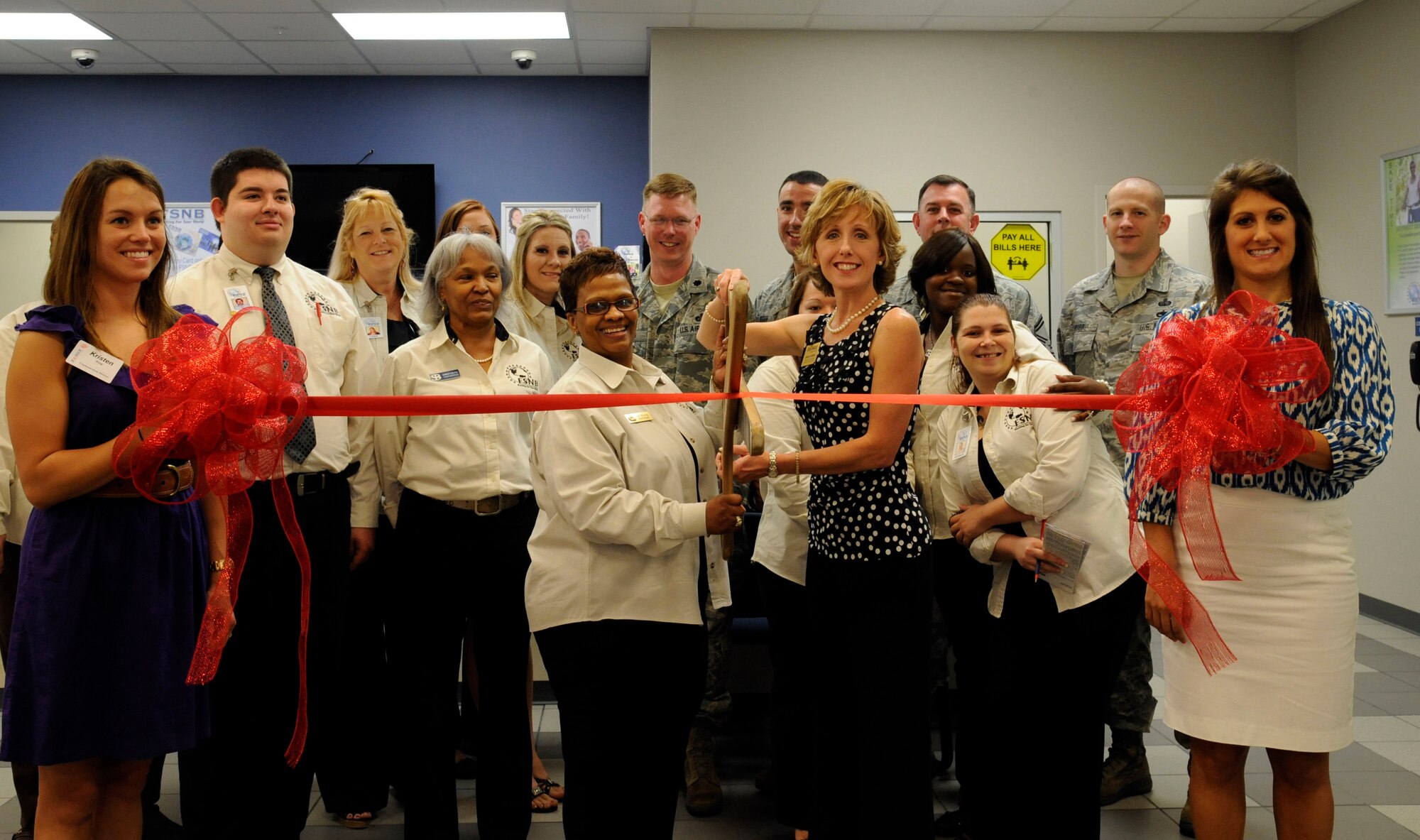 Employees of Fort Sill National Bank, members of the Bossier City Chamber of Commerce and members of the 2nd Comptroller Squadron prepare to cut the ribbon of the newly constructed bank on Barksdale Air Force Base, La., June 6. The new bank provides customers with a convenient and central location for their banking needs. (U.S. Air Force photo/Airman 1st Class Andrew Moua)(RELEASED)
