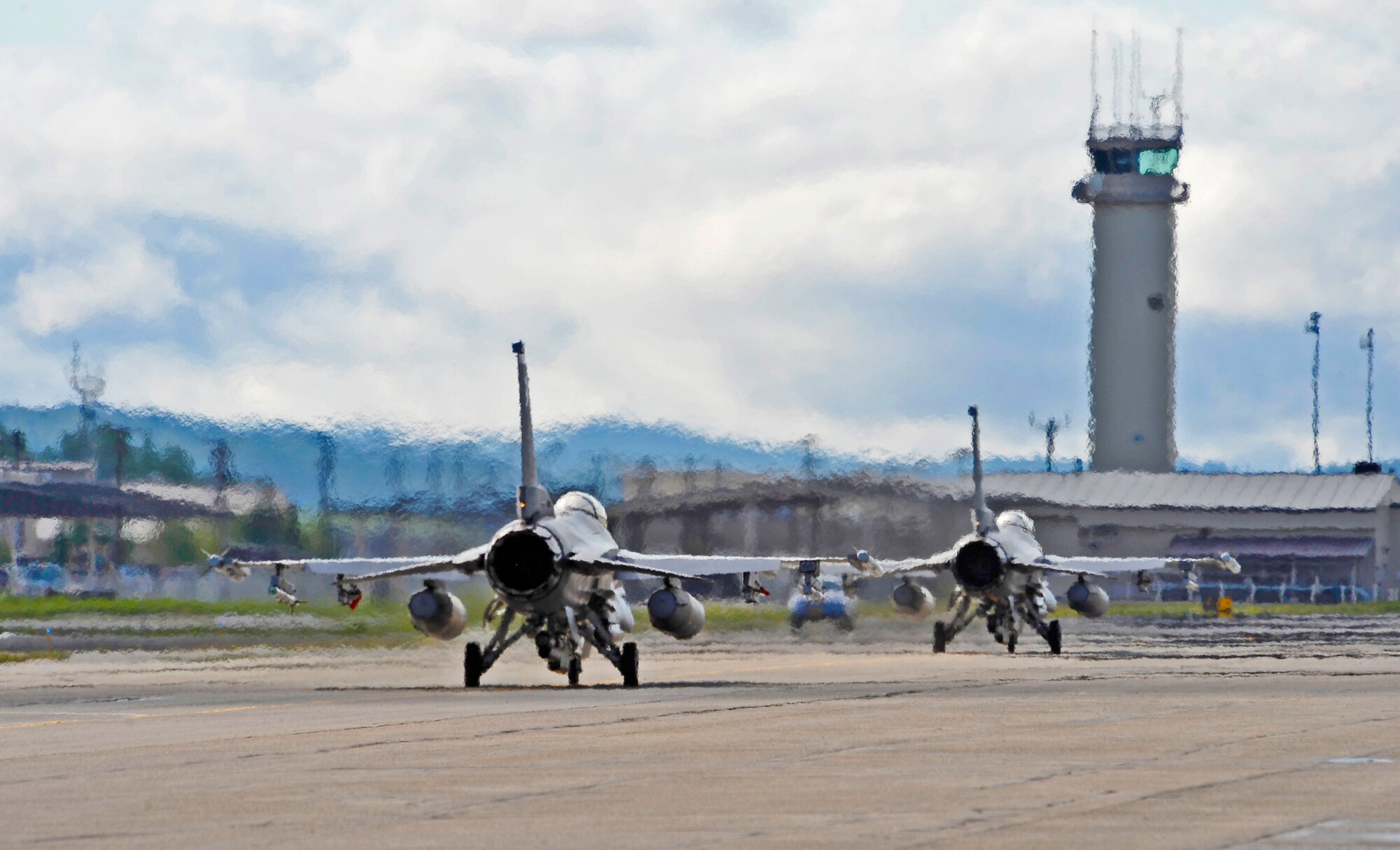 Two F-16 Fighting Falcons taxi the runway prior to take off in preparation for RED FLAG-Alaska 12-2 June 4, 2012, Eielson Air Force Base, Alaska.  RF-A allows participating units to exchange tactics, techniques and procedures as well as improve interoperability.  The F-16 aircraft are assigned to the 77th Fighter Squadron at Shaw Air Force Base, S.C.  (U.S. Air Force photo/Staff Sgt. Miguel Lara III)