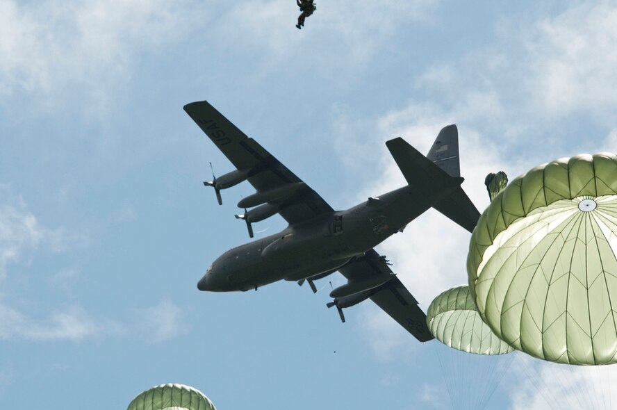 American and allied paratroopers jump from a 302nd Airlift Wing C-130 June 3, 2012, while re-enacting the D-Day airborne operation on the La Fiere fields near Sainte Mere Eglise, France. The drops commemorated the heroic Normandy invasion of World War II paratroopers who made the jump 68 years ago. After the jump, the American and allied troops marched into the village to the sounds of cheers from local residents. The paratrooper drop was one of the highlights in northern France commemorating the 68th anniversary of D-Day. The 302nd AW is an Air Force Reserve Command organization. (U.S. Army photo/Staff Sgt. Sharilyn Wells)