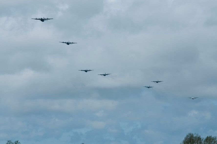 A C-130 from the 302nd Airlift Wing, Air Force Reserve along with additional U.S. Air Force C-130s and allied aircraft, prepare to drop paratroopers June 3, 2012, re-enacting the D-Day airborne operation on the La Fiere fields near Sainte Mere Eglise, France. The drops commemorated the heroic Normandy invasion of World War II paratroopers who made the jump 68 years ago. After the jump, the American and allied troops marched into the village to the sounds of cheers from local residents. The paratrooper drop was one of the highlights in northern France commemorating the 68th anniversary of D-Day. (U.S. Army photo/Staff Sgt. Sharilyn Wells)