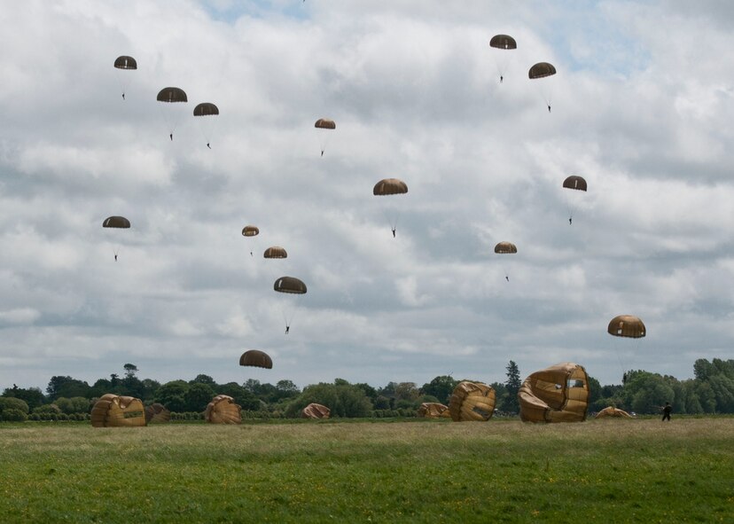 American and allied paratroopers fall to earth June 3, 2012, while re-enacting the D-Day airborne operation on the La Fiere fields near Sainte Mere Eglise, France. The drops commemorated the heroic Normandy invasion of World War II paratroopers who made the jump 68 years ago. After the jump, Americans and allied troops marched into the village to the sounds of cheers from local residents. The paratrooper drop was one of the highlights in northern France commemorating the 68th anniversary of D-Day. (U.S. Army photo/Staff Sgt. Sharilyn Wells)