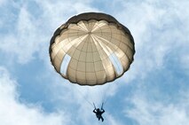 An allied paratrooper falls to earth June 3, 2012, while re-enacting the D-Day airborne operation on the La Fiere fields near Sainte Mere Eglise, France. The drops commemorated the heroic Normandy invasion of World War II paratroopers who made the jump 68 years ago. After the jump, Americans and allied troops marched into the village to the sounds of cheers from local residents. The paratrooper drop was one of the highlights in northern France commemorating the 68th anniversary of D-Day. (U.S. Army photo/Staff Sgt. Sharilyn Wells)