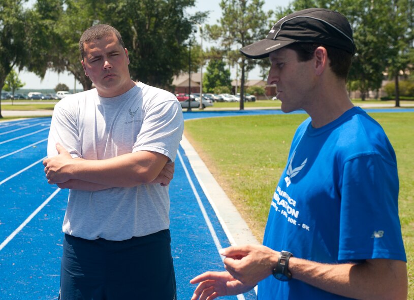 U.S. Air Force Master Sgt. Jeff Posey, 820th Combat Operations Squadron NCO in charge of deployed data communications, listens to Lt. Col. Mark Cucuzzella, Air Force Marathon medical consultant and Efficient Running Program subject matter lead, about the importance of proper running form to minimize injury at Moody Air Force Base, Ga., May 30, 2012. Cucuzzella began researching and teaching proper running form after injuries nearly forced him to give up running. (U.S. Air Force photo by Airman 1st Class Jarrod Grammel/Released) 
