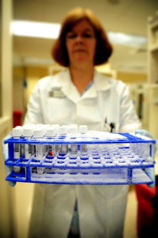 Lea Shoup, a medical lab technician with the Naval Health Clinic at Joint Base Charleston – Weapons Station, S.C., displays a crate of frozen donated blood plasma stored at the clinic June 1, 2012. Frozen plasma is able to be stored for years and sent around the world for testing. (U.S. Air Force illustration / Senior Airman Dennis Sloan)