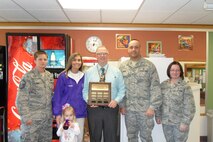 MINOT AIR FORCE BASE, N.D. -- Master Sgt. Lori Ehlo, Relay for Life Champion and Cancer survivor Michelle Betz and daughter Madyson, Principle Strand, 1st Lt. Ron Sears and Capt. Julia Focht-- the group contributed to this year’s  fight against cancer during the third Annual Penny War Competition at the North Plains Elementary School. In total this year, the North Plains Elementary School raised $1,910 notably beating 2011’s total of $1,421.14. (Courtesy photo)

