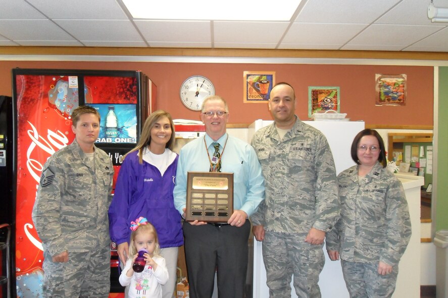 MINOT AIR FORCE BASE, N.D. -- Master Sgt. Lori Ehlo, Relay for Life Champion and Cancer survivor Michelle Betz and daughter Madyson, Principle Strand, 1st Lt. Ron Sears and Capt. Julia Focht-- the group contributed to this year’s  fight against cancer during the third Annual Penny War Competition at the North Plains Elementary School. In total this year, the North Plains Elementary School raised $1,910 notably beating 2011’s total of $1,421.14. (Courtesy photo)

