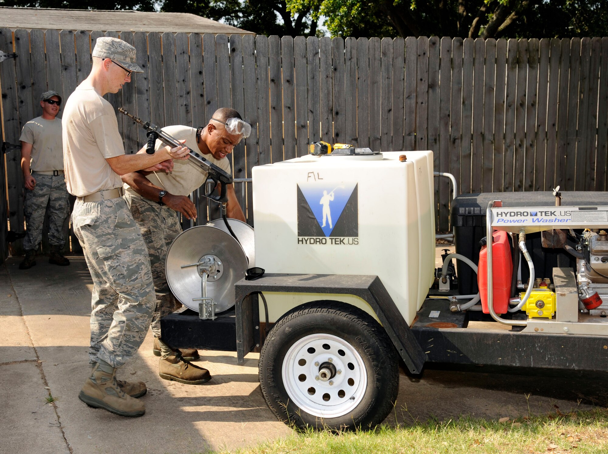 Airmen 1st Class Matthew Clover and Juan Leverette, 2nd Civil Engineer Squadron Heating, Ventilation, Air Conditioning and Refrigeration technicians, pack up a portable pressure washer on Barksdale Air Force Base, La., June 5. The Airmen recently finished cleaning dirt and debris from the air filters using the high pressure water hose. The filters are cleaned bi-annually as determined by the HVAC/R's Routine Maintenance Program. (U.S. Air Force photo/Airman 1st Class Andrew Moua)(RELEASED)
