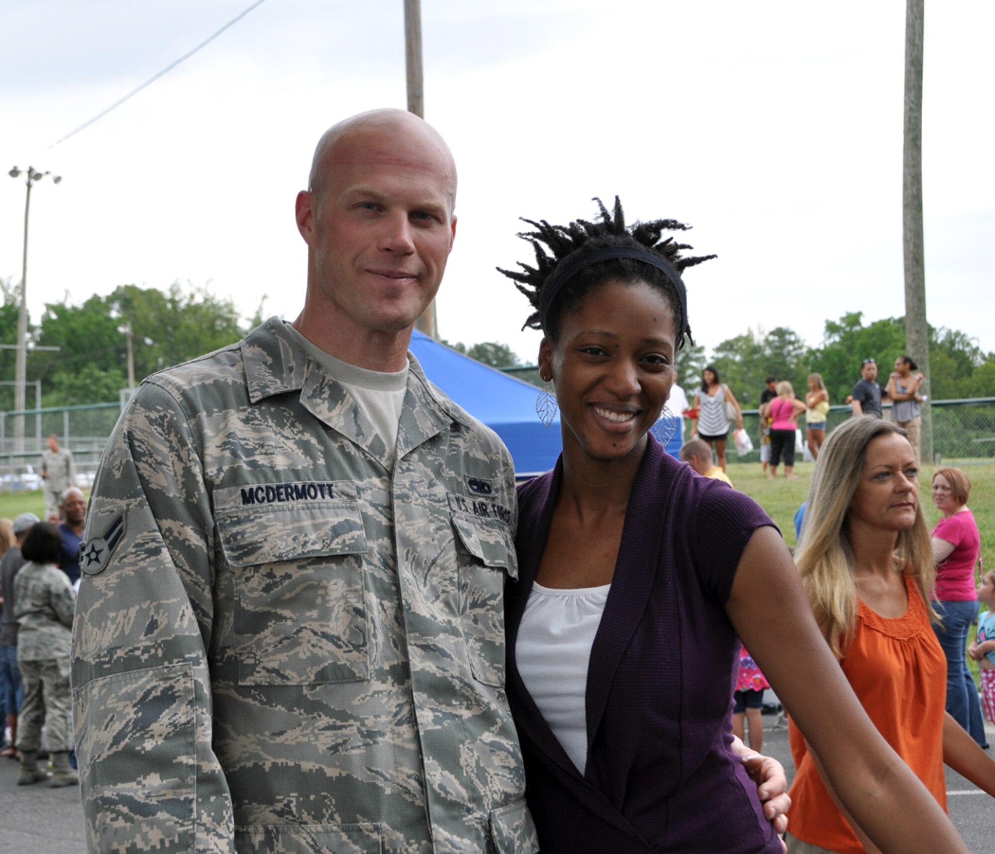 Airman 1st Class John L. McDermott IV, of the 94th Airlift Wing maintenance group, navigates through Family Day on June 3 with his girlfriend, Tracia Livingston. Family Day is an annual event celebrating the support family members give Dobbins Airmen. (U.S. Air Force photo/Senior Airman Elizabeth Gaston)