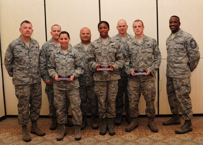 Colonel Richard McComb (left), Joint Base Charleston commander, and Chief Master Sgt. Avery Jones, 628th Mission Support Group superintendent (right), recognize June's Diamond Sharp winners at the Charleston Club at JB Charleston –Air Base, June 5. The Diamond Sharp recipients are (front row from left) Airman 1st Class Dariely Velazquez, 628th Communications Squadron, Airman 1st Class Kevonda Harrell 628th Force Support Squadron, and Airman 1st Class Kurt Davis, 628th Civil Engineer Squadron. Pictured with the Diamond Sharp winners are Master Sgt. David Turnage, 628th CS, Master Sgt. John Ward, 628 FSS and Master Sgt. Keith Bishop, 628th CE. Diamond Sharp awardees are Airmen chosen by their first sergeants for their excellent performance. (U.S. Air Force photo/Staff Sgt. Katie Gieratz)