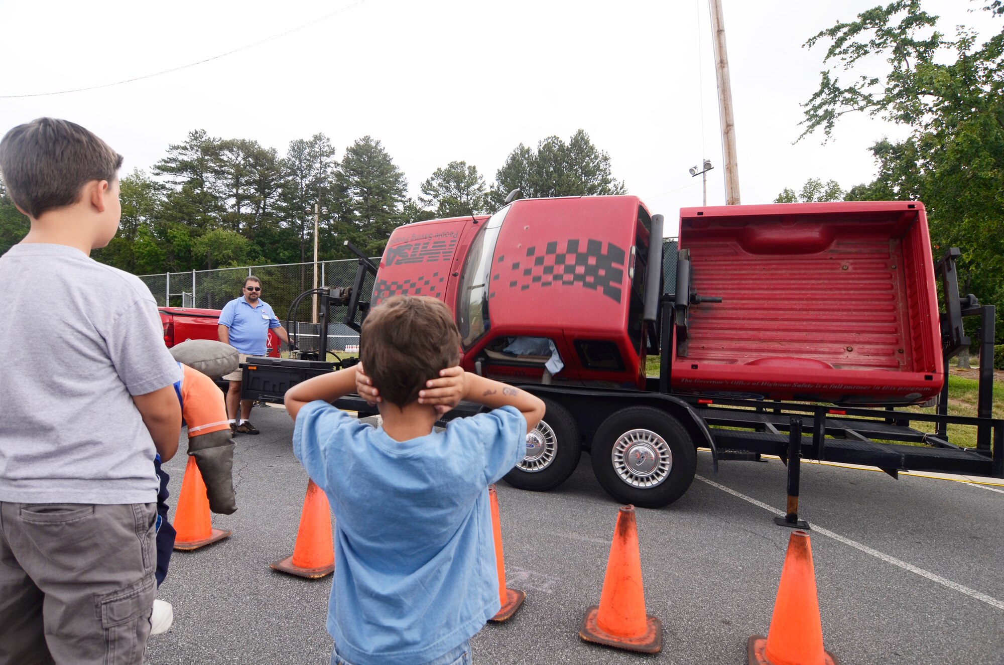 Family members learn what happens when seat belts aren't used during a roll-over demonstration, one of the attractions during the 94th Airlift Wing Annual Family Day here June 3. (U.S. Air Force photo/Don Peek)