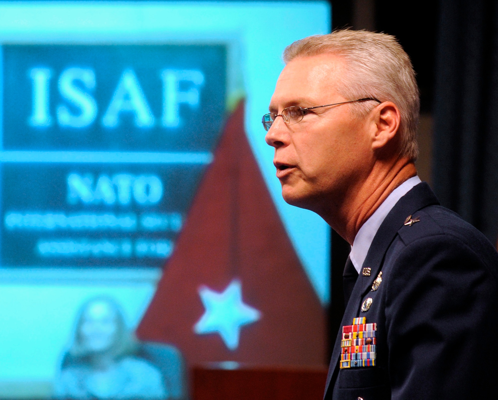 Brig. Gen. Les Kodlick, director of Air Force Public Affairs, speaks at a unique promotion ceremony for Majs. Christian and Lori Hodge at the Pentagon in Washington, D.C., June 4, 2012.   Christian attended the ceremony in person while his wife Lori, who is deployed to Kabul, Afghanistan, participated via video teleconference.  The two were promoted from captain to the rank of major during the ceremony.  (U.S. Air Force photo/Andy Morataya)