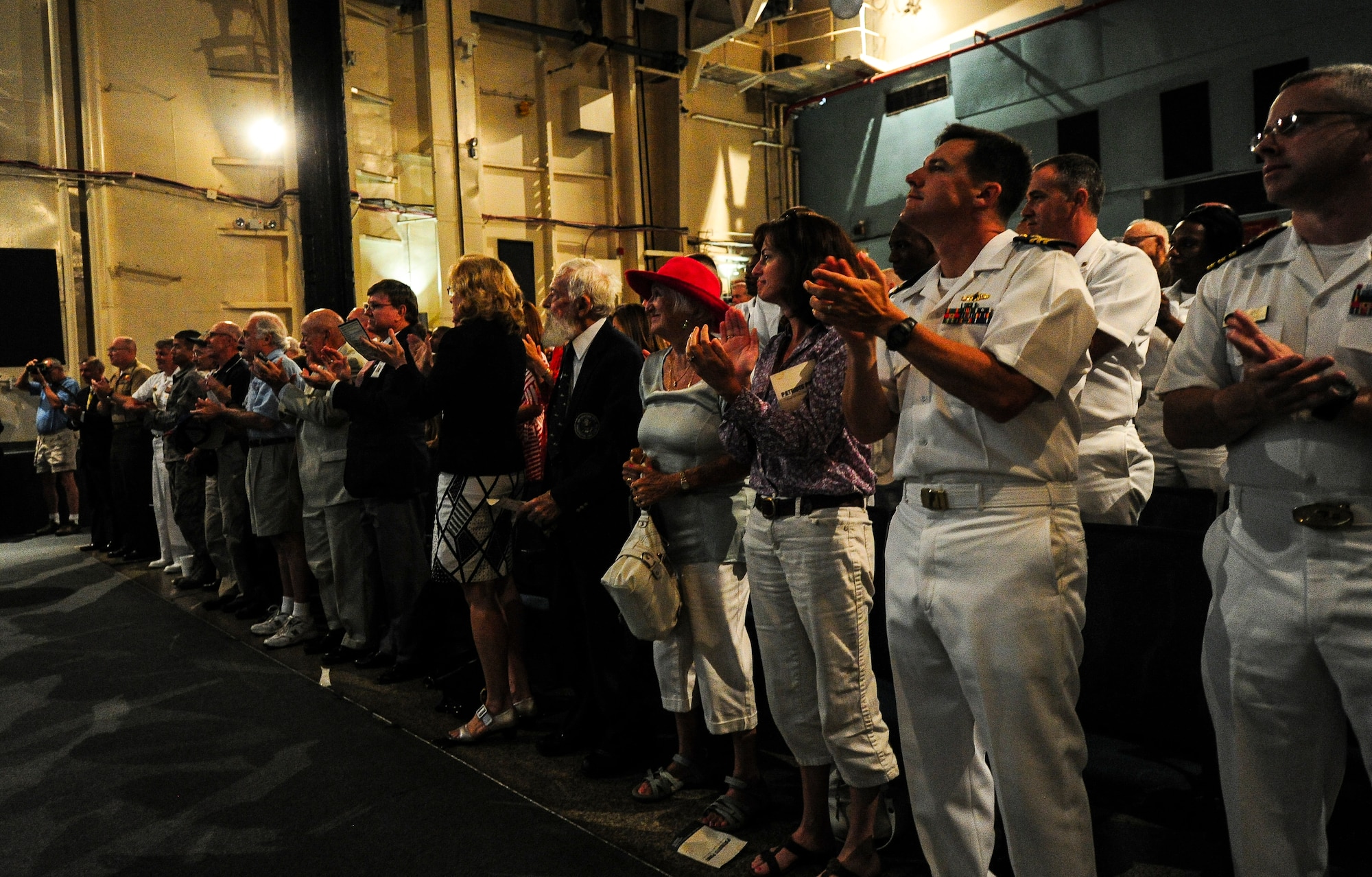 The crowd on board the USS Yorktown (CV-10) applauds John Hancock June 4, 2012, after he delivered his story describing his actions during the Battle of Midway. Hancock watched several of his friends die during the battle. He suffered a neck wound and a collapsed lung during the battle. He abandoned ship and waited to be rescued for hours. (U.S. Air Force photo/Senior Airman Dennis Sloan)