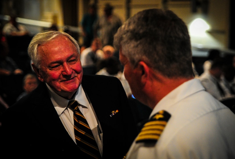 U.S. Navy Capt. Thomas Bailey, Joint Base Charleston deputy commander, speaks with John Hancock, retired U.S. Navy captain and Battle of Midway survivor, before the Battle of Midway ceremony on board the USS Yorktown (CV-10), S.C., June 4, 2012. Hancock was on board the USS Yorktown (CV-5) during the battle. He served as a machine-gun operator and suffered wounds to his neck as well as a collapsed lung during the attack. (U.S. Air Force photo/Senior Airman Dennis Sloan)