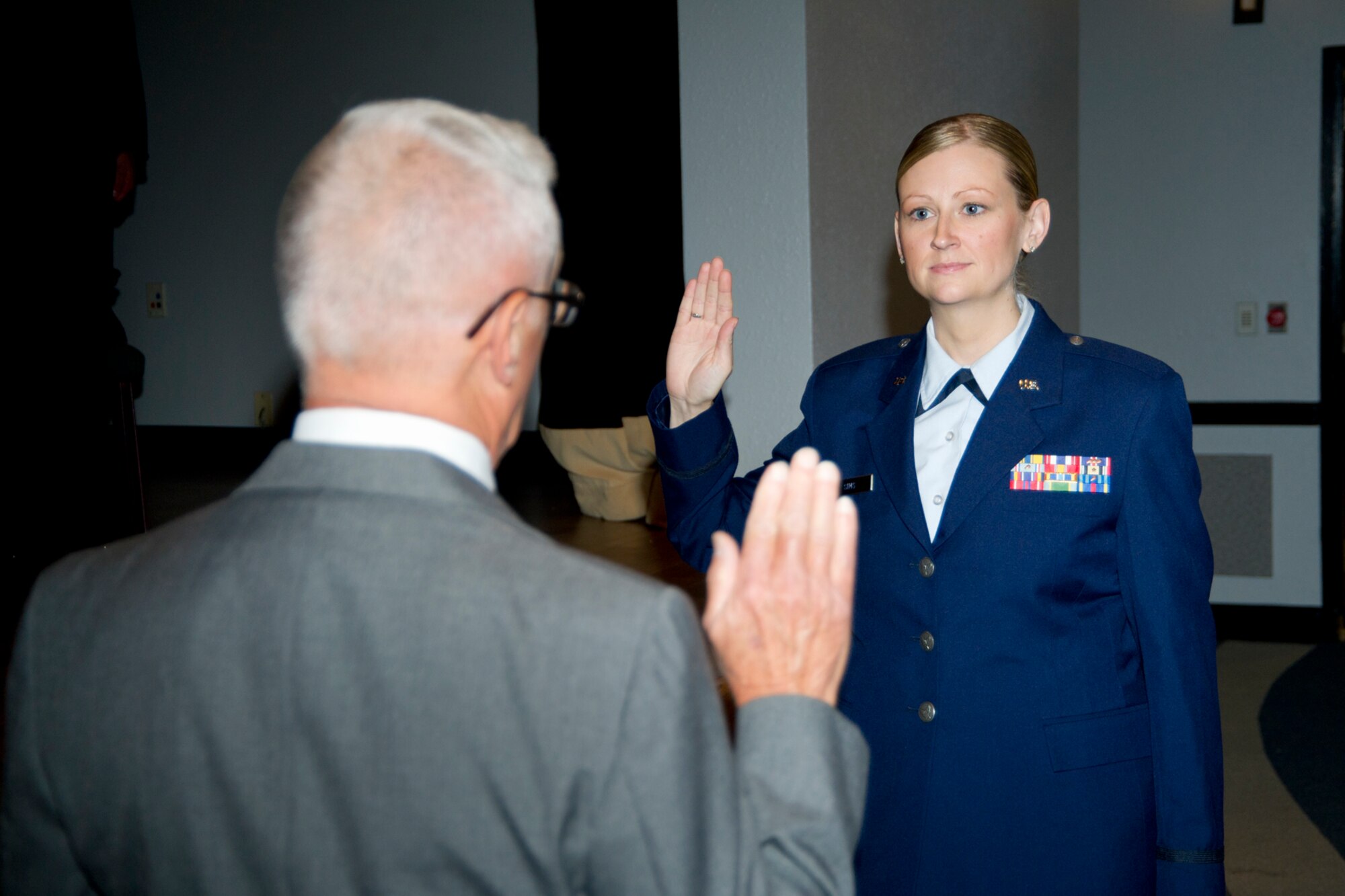Retired Navy Lt. Harold Marenbach administered the oath of office to 1st Lt. Sarah Sims, 81st Medical Operations Squadron, after receiving her physician assistants diploma May 10, 2012, at the Keesler Hospital's Don Wylie Auditorium at Keesler Air Force Base, Miss. (U.S. Air Force photo by Adam Bond)