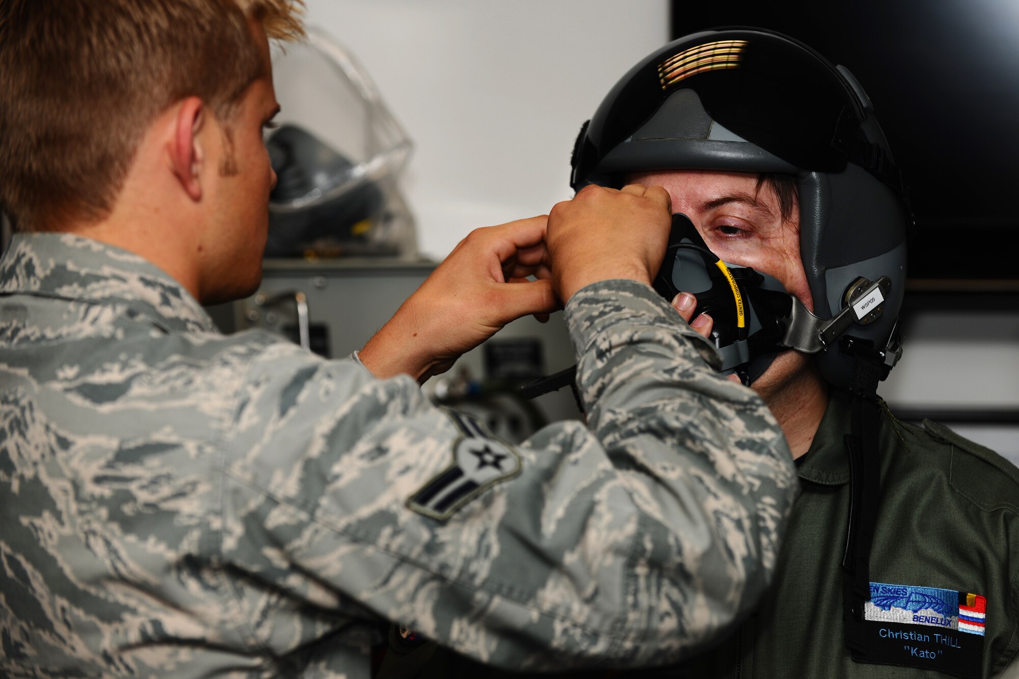 SPANGDAHLEM AIR BASE, Germany – Airman 1st Class Ryan Jelstrom, 52nd Operations Support Squadron aircrew flight-equipment technician, attaches a breathing mask onto a helmet worn by Christian Thill, evaluation team member, during an exercise of the Vienna Document 11 evaluation here June 5. The exercise was conducted to ensure the base is prepared for procedures used during an actual Vienna Document evaluation. (U.S. Air Force photo by Airman 1st Class Matthew B. Fredericks/Released)