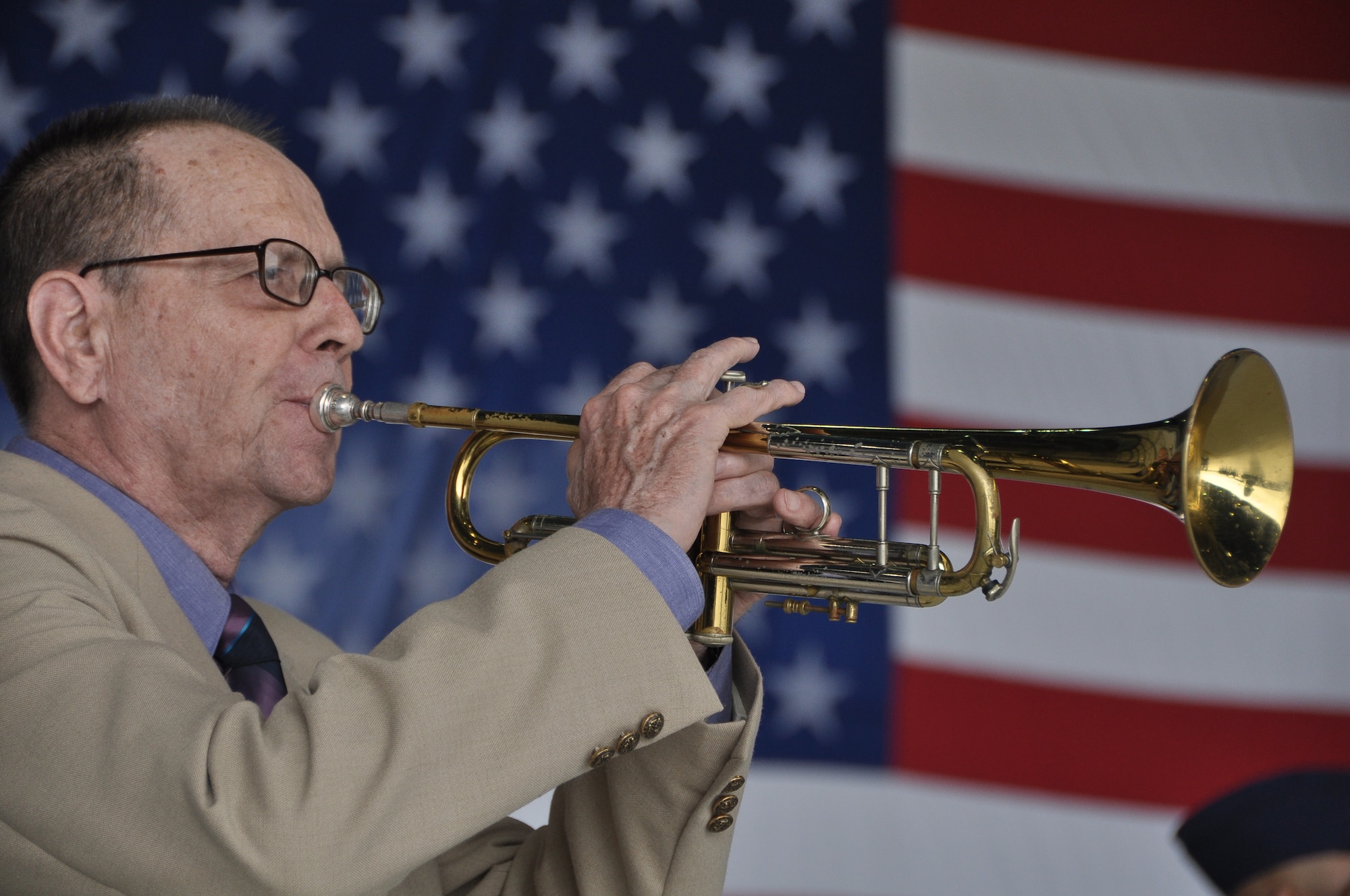 Mr. Brian Pennington, father of incoming commander, Col. Jeffrey T. Pennington playing the National Anthem trumpet during the 433rd Airlift Wing’s change of command ceremony at Joint Base San Antonio – Lackland AFB, Texas. (U.S. Air Force photo/Senior Airmen Brian McGloin)