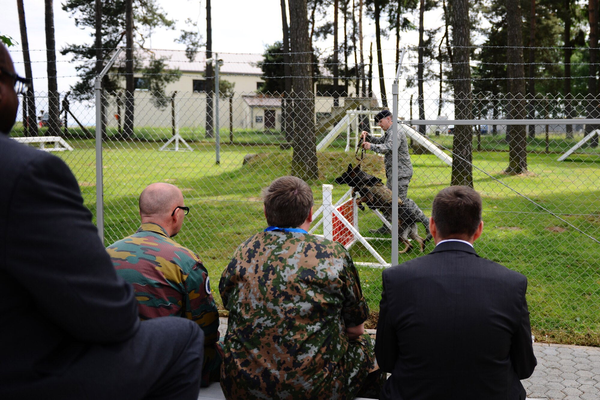SPANGDAHLEM AIR BASE, Germany – Vienna Document 11 evaluation team members from Luxembourg and Belgium watch a military working dog demonstration at Bldg. 985 here during an exercise of the Vienna Document 11 evaluation here June 5. The exercise was conducted to ensure the base is prepared for procedures used during an actual Vienna Document evaluation. (U.S. Air Force photo by Airman 1st Class Matthew B. Fredericks/Released)