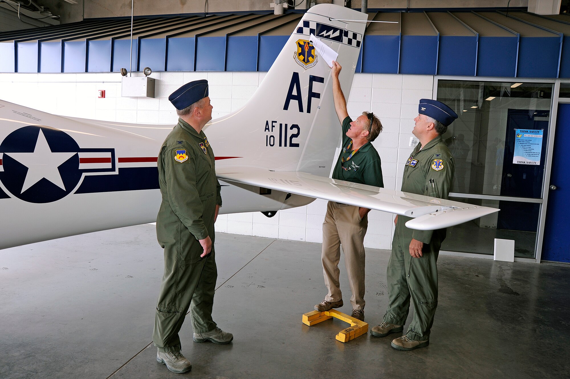 The 12th FTW tail flash is unveiled on a T-53A trainer during a redesignation ceremony at the U.S. Air Force Academy's airfield in Colorado Springs, Colo. June 6, 2012.   Led by 12th Flying Training Wing commander Col. RIchard Murphy and Col. Richard Plamp, commander 306th Flying Training Group, the 12th FTW took formal control of the group June 1 by order of Gen. Edward Rice, commander of Air Education and Training Command, due to the scheduled inactivation of the 19th Air Force.    (U.S. Air Force photo/Mike Kaplan) 