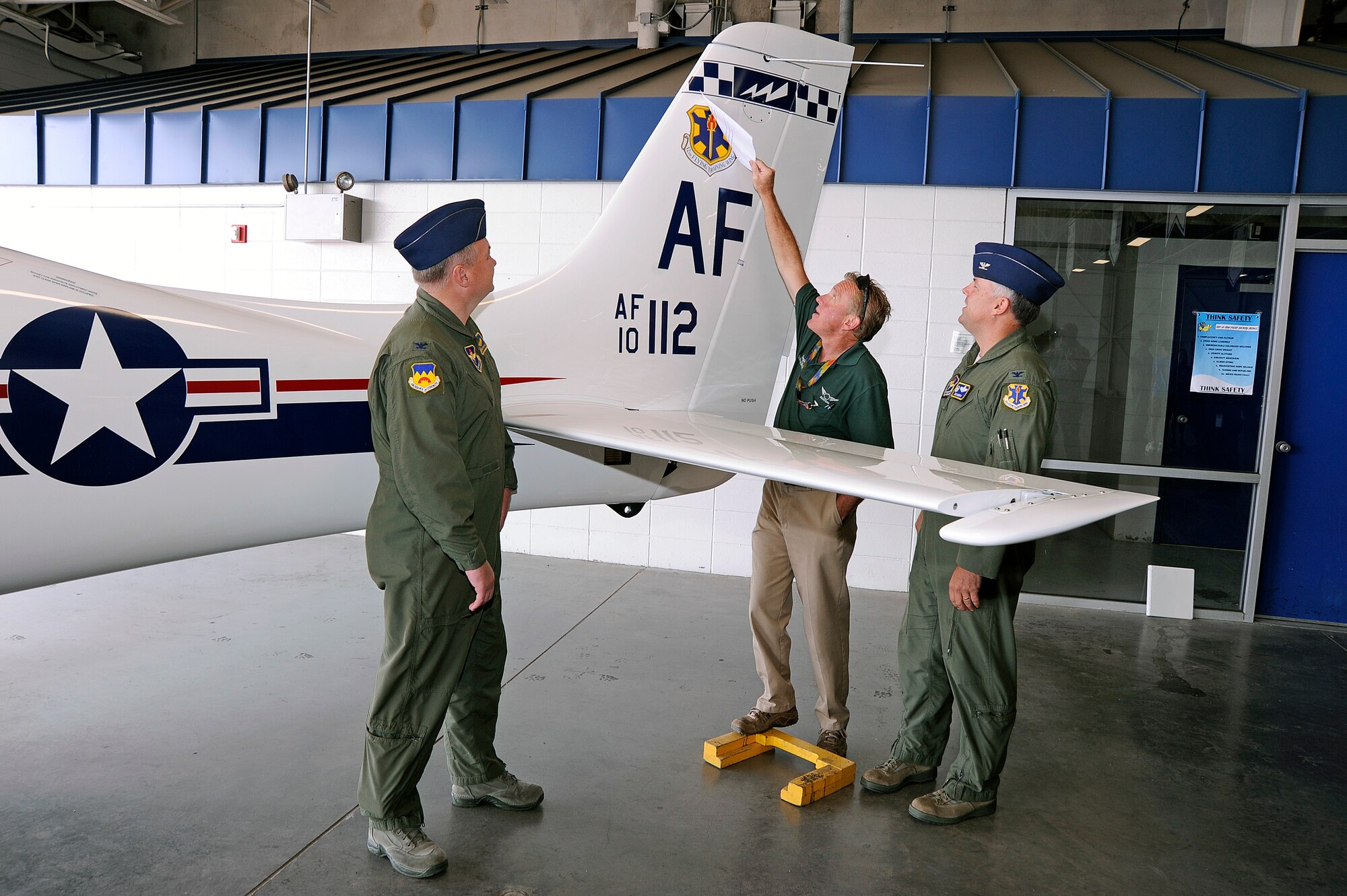 The 12th FTW tail flash is unveiled on a T-53A trainer during a redesignation ceremony at the U.S. Air Force Academy's airfield in Colorado Springs, Colo. June 6, 2012.   Led by 12th Flying Training Wing commander Col. RIchard Murphy and Col. Richard Plamp, commander 306th Flying Training Group, the 12th FTW took formal control of the group June 1 by order of Gen. Edward Rice, commander of Air Education and Training Command, due to the scheduled inactivation of the 19th Air Force.    (U.S. Air Force photo/Mike Kaplan) 