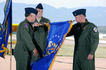 Col. Richard Murphy, commander 12th Flying Training Wing and Col. Richard Plamp, commander 306th Flying Training Group, U.S. Air Force Academy, Colo. uncases the 12th FTW flag during a redesignation ceremony at the Academy's airfield in Colorado Springs, Colo. June 6, 2012.   The 12th FTW took formal control of the group June 1 by order of Gen. Edward Rice, commander of Air Education and Training Command, due to the scheduled inactivation of the 19th Air Force.    (U.S. Air Force photo/Mike Kaplan) 