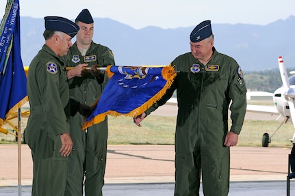 Col. Richard Murphy, commander 12th Flying Training Wing and Col. Richard Plamp, commander 306th Flying Training Group, U.S. Air Force Academy, Colo. uncases the 12th FTW flag during a redesignation ceremony at the Academy's airfield in Colorado Springs, Colo. June 6, 2012.   The 12th FTW took formal control of the group June 1 by order of Gen. Edward Rice, commander of Air Education and Training Command, due to the scheduled inactivation of the 19th Air Force.    (U.S. Air Force photo/Mike Kaplan) 