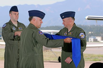 Col. Richard Murphy, commander 12th Flying Training Wing and Col. Richard Plamp, commander 306th Flying Training Group, U.S. Air Force Academy, Colo. uncases the 12th FTW flag during a redesignation ceremony at the Academy's airfield in Colorado Springs, Colo. June 6, 2012.   The 12th FTW took formal control of the group June 1 by order of Gen. Edward Rice, commander of Air Education and Training Command, due to the scheduled inactivation of the 19th Air Force.    (U.S. Air Force photo/Mike Kaplan) 