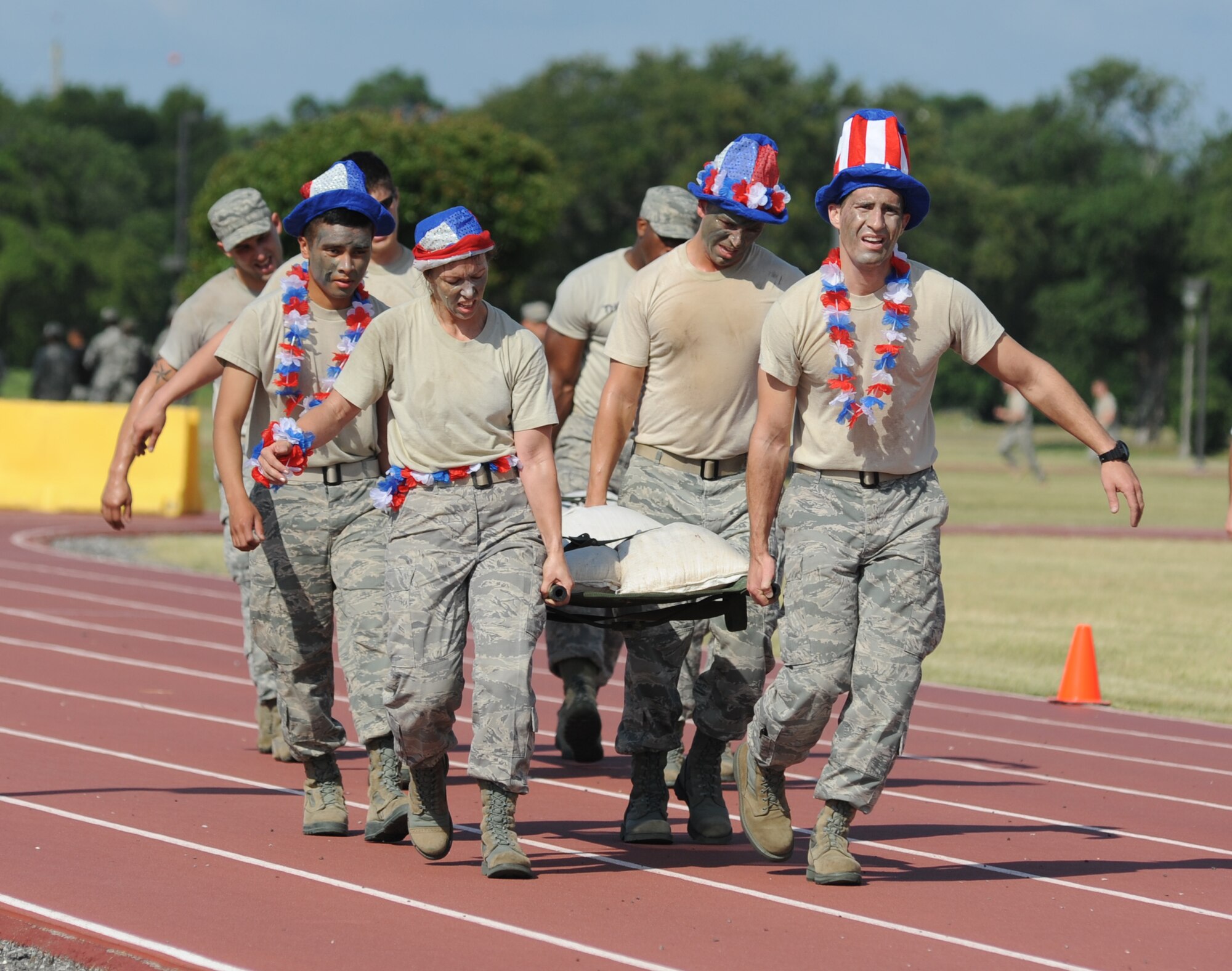 Airman First Class Daniel Blas, Master Sgt. Casy Boomershine, Staff Sgt. Marc Skinner, and 1st Lt. Kyle Davis, The Logitators from the 81st Logistics Readiness Squadron, participate in the “Litter Carry” challenge during the 81st Mission Support Group Ultimate Warrior Challenge June 1, 2012, at the Triangle Track at Keesler Air Force Base, Miss.  The challenge consisted of retrieving four sandbags, placing them securely on a litter and carry to the next challenge starting point.  The challenge was held in honor of fellow service members who lost their lives in the fight for our nation’s freedom. It consisted of nine four-member teams racing in a competition designed to take them through various aspects of a deployment. The Ram Rods were the first place winners of the Ultimate Warrior Challenge.  (U.S. Air Force photo by Kemberly Groue)