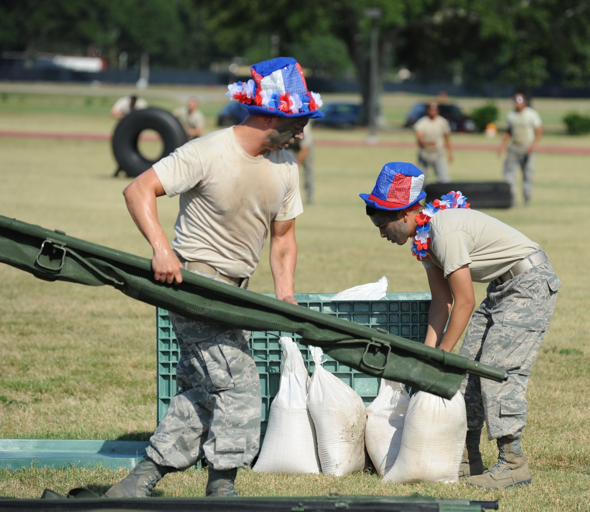 Staff Sgt. Marc Skinner and Airman 1st Class Daniel Blas, The Logitators from the 81st Logistics Readiness Squadron, begin the “Litter Carry” challenge, which consisted of retrieving four sandbags, placing them securely on a litter and carrying to the next challenge starting point during the 81st Mission Support Group Ultimate Warrior Challenge June 1, 2012, at the Triangle Track at Keesler Air Force Base, Miss.  The challenge was held in honor of fellow service members who lost their lives in the fight for our nation’s freedom. It consisted of nine four-member teams racing in a competition designed to take them through various aspects of a deployment. The Ram Rods were the first place winners of the Ultimate Warrior Challenge.  (U.S. Air Force photo by Kemberly Groue)