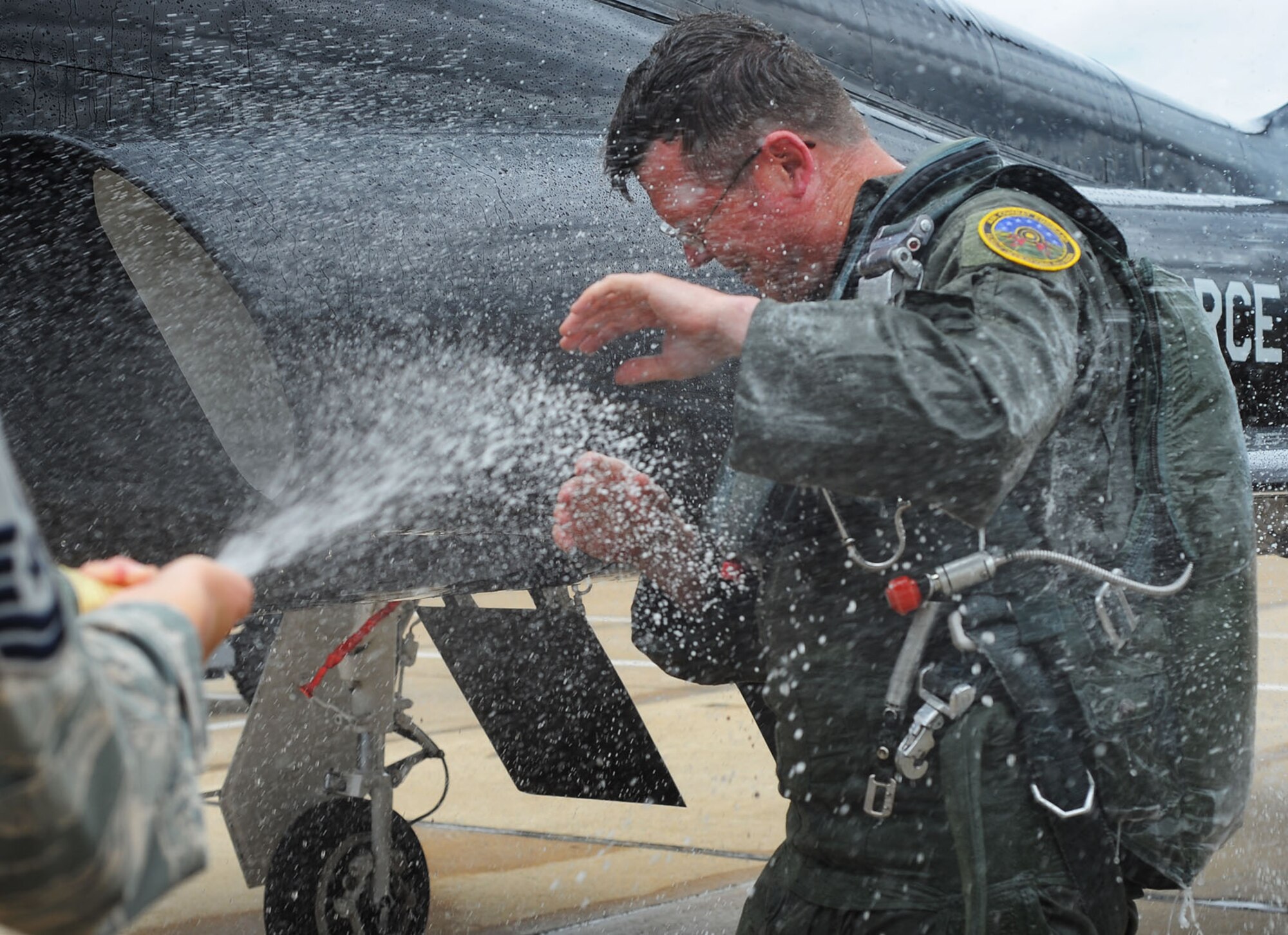 Airmen spray U.S. Air Force Chief Master Sgt. Kevin Howell, 633rd Air Base Wing command chief, with champagne and fire extinguishers upon completion of his last flight as an Airman, June 5, 2012, at Langley Air Force Base, Va. Howell, who began his career in 1983 as an Aerospace Control and Warning Systems operator, will retire from the Air Force June 15.  (U.S. Air Force photo by Tech. Sgt. Barry Loo/Released)