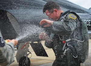Airmen spray U.S. Air Force Chief Master Sgt. Kevin Howell, 633rd Air Base Wing command chief, with champagne and fire extinguishers upon completion of his last flight as an Airman, June 5, 2012, at Langley Air Force Base, Va. Howell, who began his career in 1983 as an Aerospace Control and Warning Systems operator, will retire from the Air Force June 15.  (U.S. Air Force photo by Tech. Sgt. Barry Loo/Released)